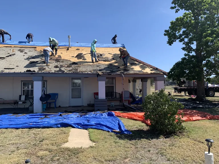 5 Star Roofing crew installing a new shingle roof during a residential tearoff in West Texas